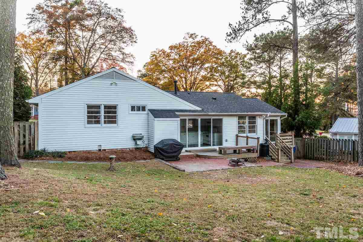 307 Acorn Street Raleigh, NC 27604 - Photo 18 of 24 a front view of a house with a yard and trees