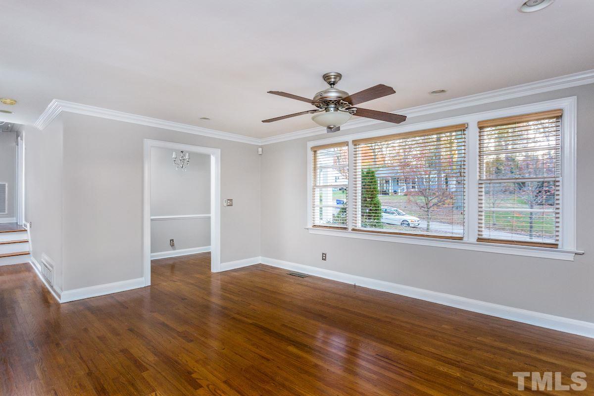 307 Acorn Street Raleigh, NC 27604 - Photo 3 of 24 a view of an empty room with wooden floor and a window