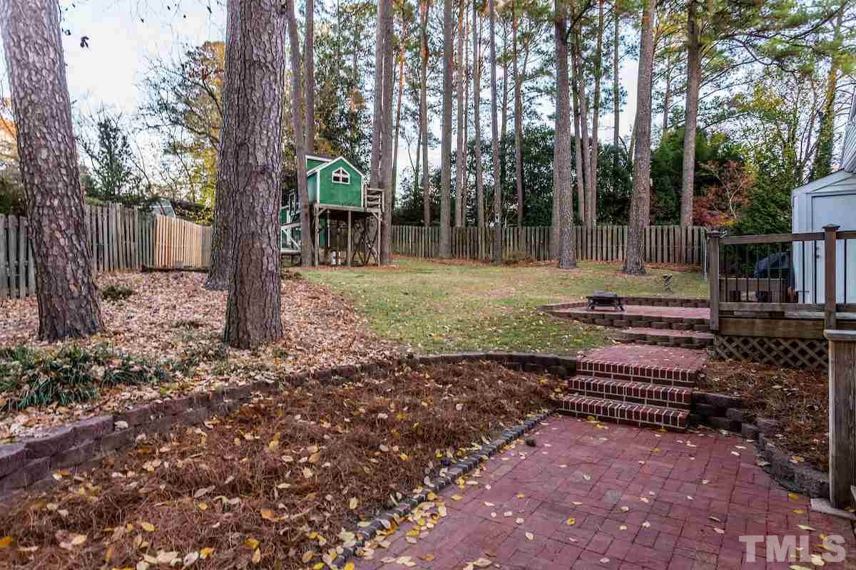 307 Acorn Street Raleigh, NC 27604 - Photo 22 of 24 a backyard of a house with lots of green space