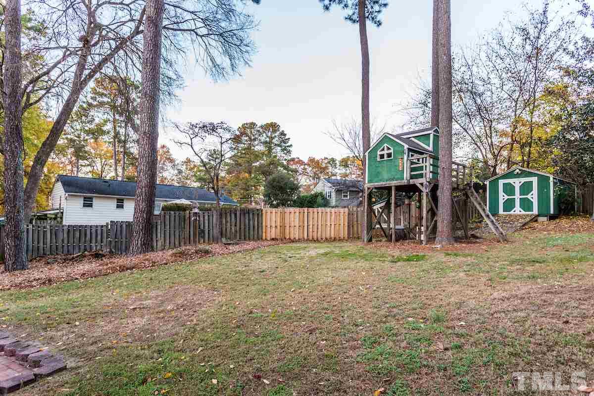 307 Acorn Street Raleigh, NC 27604 - Photo 23 of 24 a backyard of a house with lots of green space