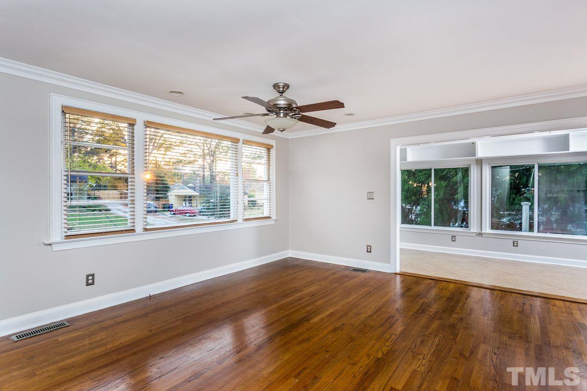 307 Acorn Street Raleigh, NC 27604 - Photo 4 of 24 a view of an empty room with wooden floor and a window