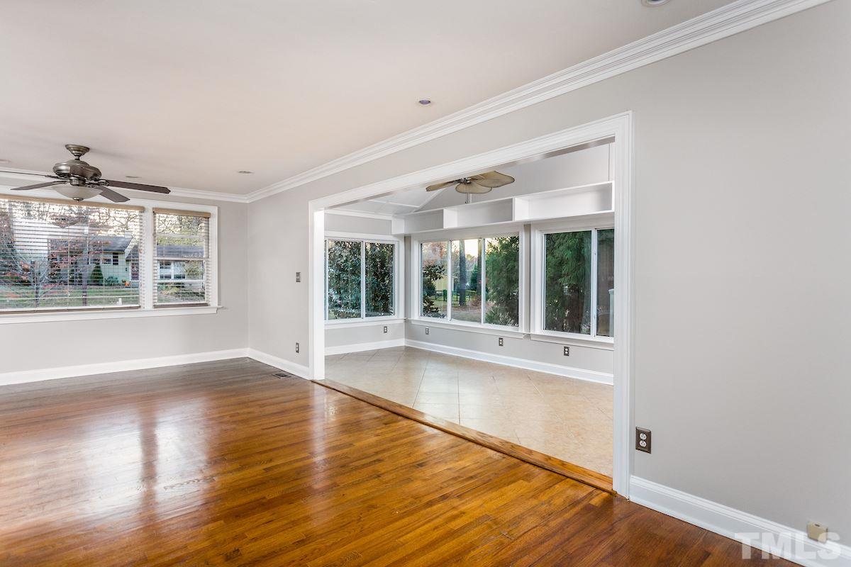 307 Acorn Street Raleigh, NC 27604 - Photo 7 of 24 a view of an empty room with wooden floor and a window
