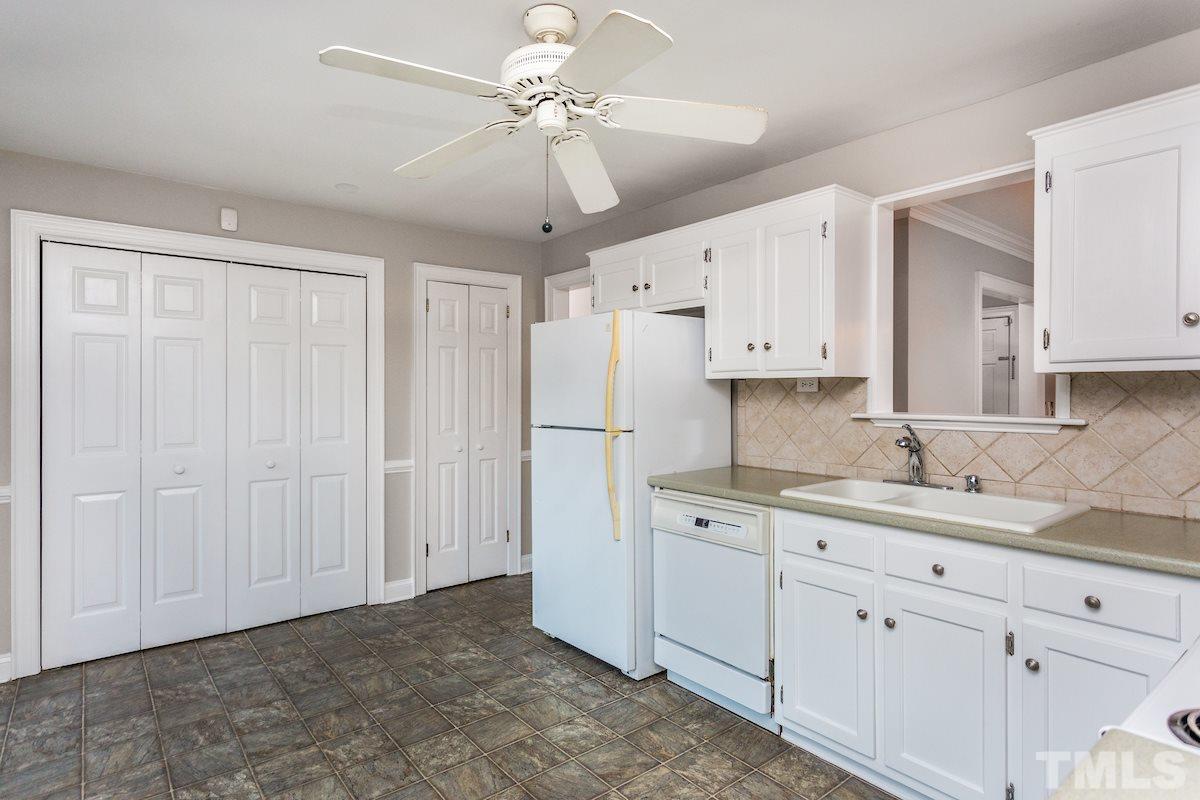 307 Acorn Street Raleigh, NC 27604 - Photo 10 of 24 a kitchen with cabinets appliances and a ceiling fan