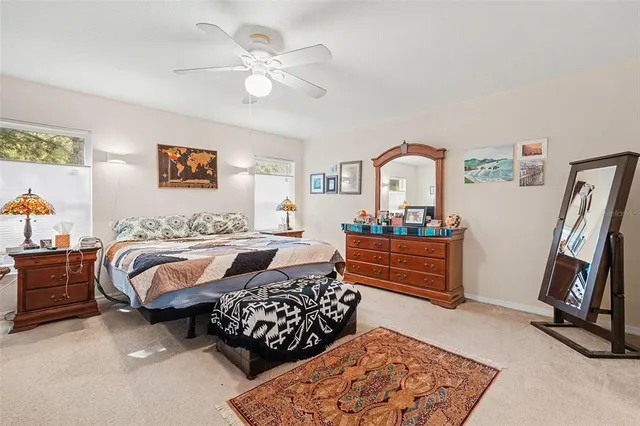 a bedroom with furniture and a mirror