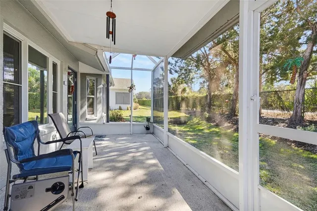a view of a porch with chairs and backyard