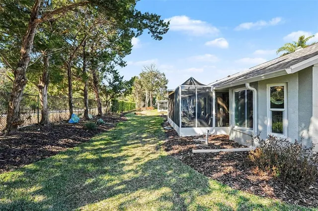 a view of a house with backyard sitting area and garden