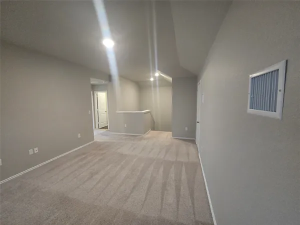 a view of a room with wooden floor and windows