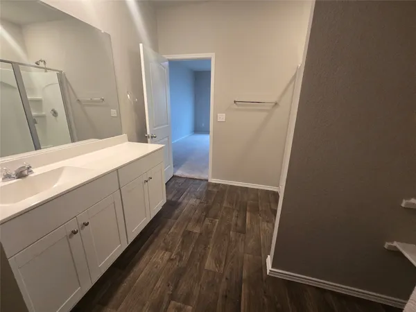 a bathroom with a sink a mirror and a shower