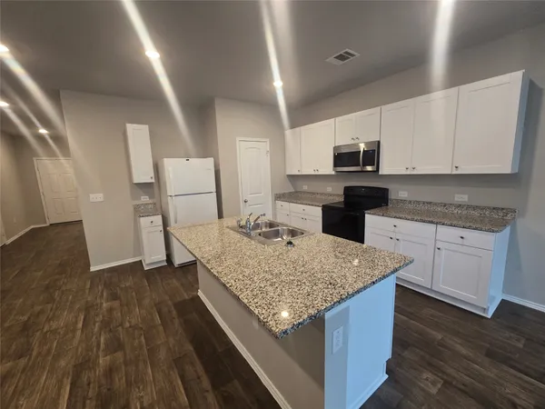 a kitchen with a sink and cabinets