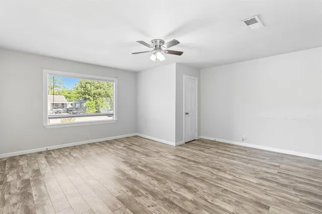 a view of a room with a ceiling fan