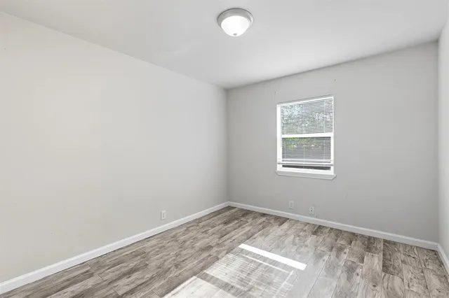 a kitchen with granite countertop white cabinets and stainless steel appliances