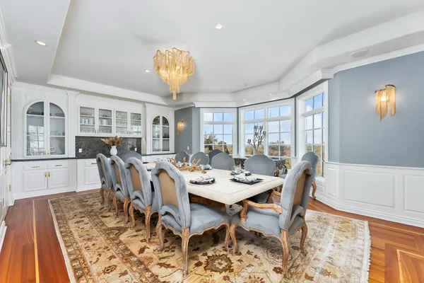 a spacious bedroom with a bed and a chandelier