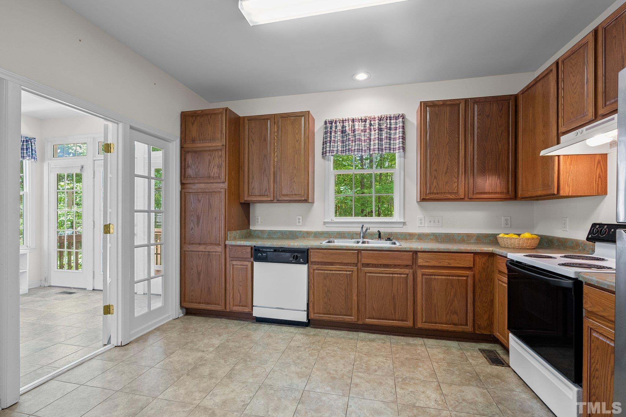 37 Lure Court Durham, NC 27713 - Photo 11 of 35 a kitchen with stainless steel appliances granite countertop wooden cabinets a sink and a stove