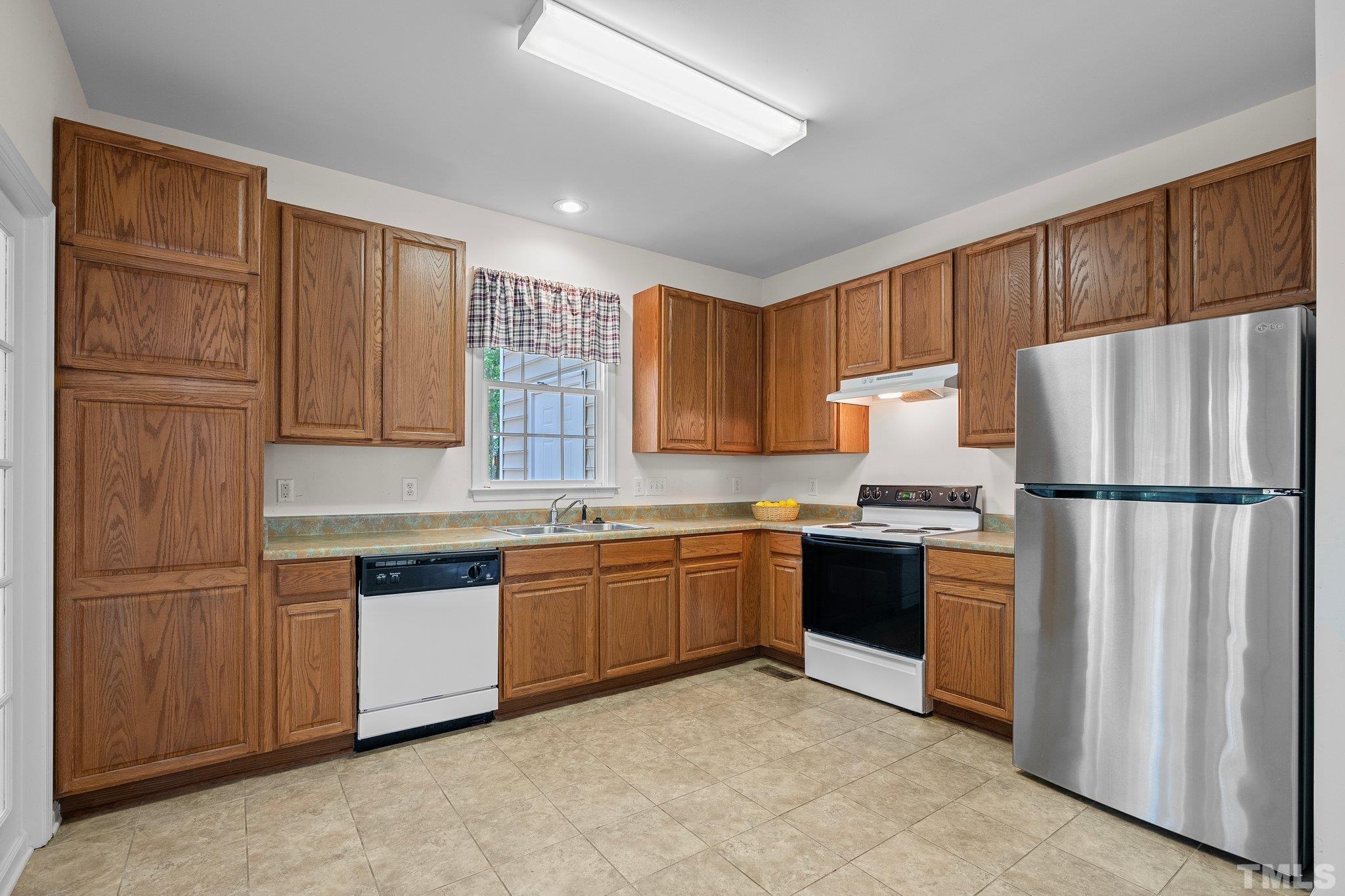 37 Lure Court Durham, NC 27713 - Photo 12 of 35 a kitchen with stainless steel appliances granite countertop a refrigerator stove top oven and sink