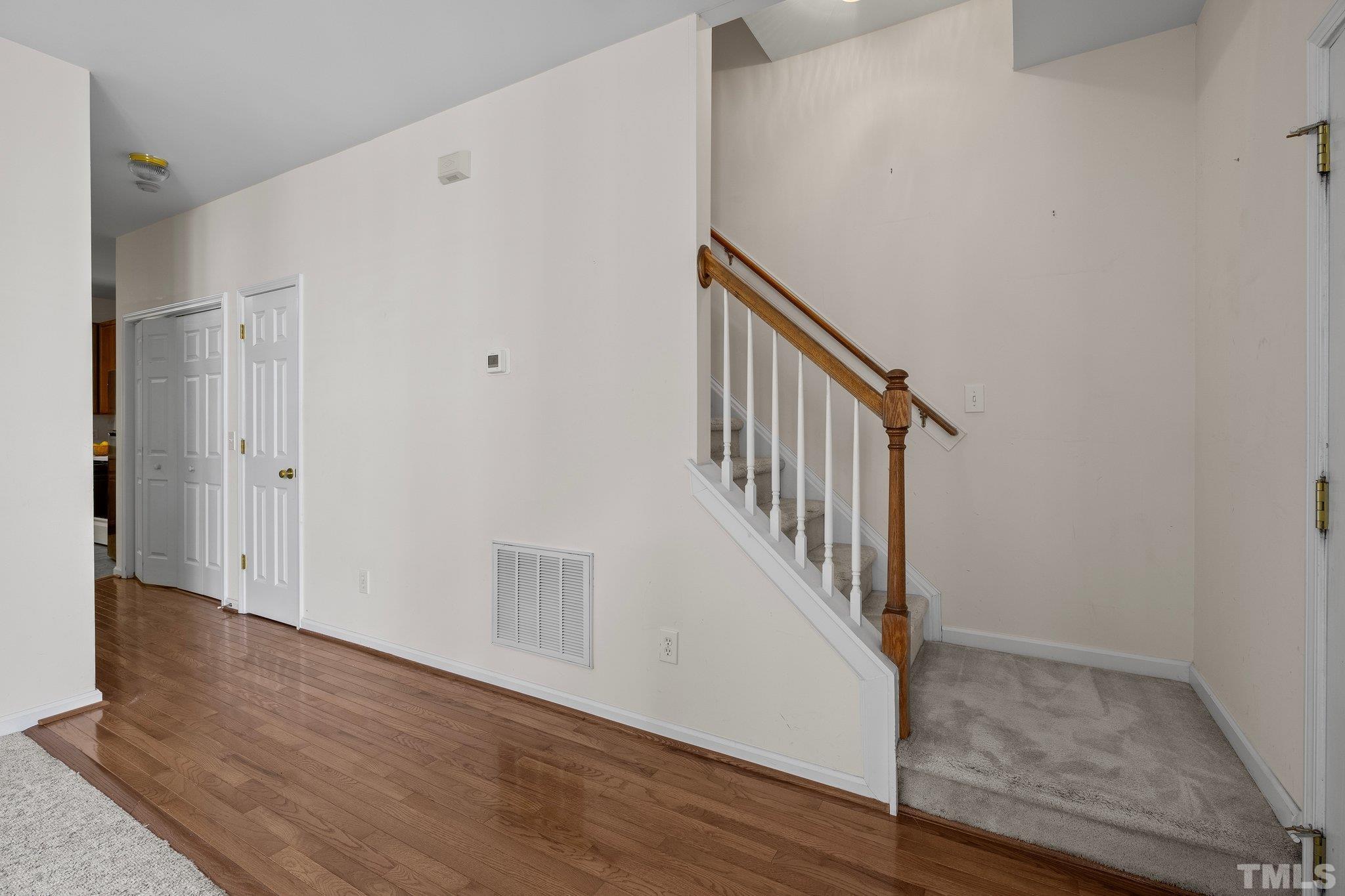 37 Lure Court Durham, NC 27713 - Photo 19 of 35 a view of a hallway with wooden floor and staircase