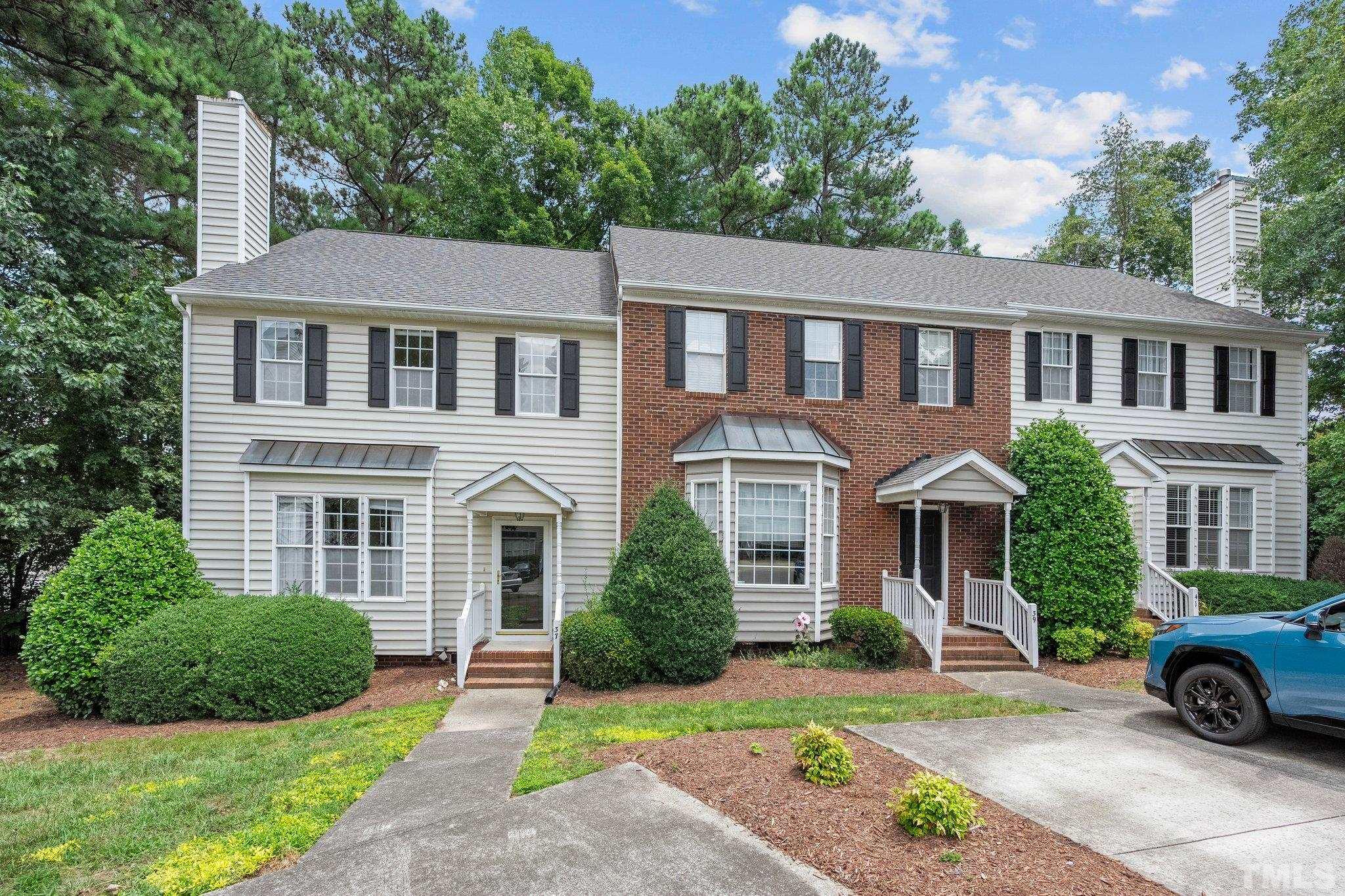 37 Lure Court Durham, NC 27713 - Photo 2 of 35 a front view of a house with a yard and potted plants