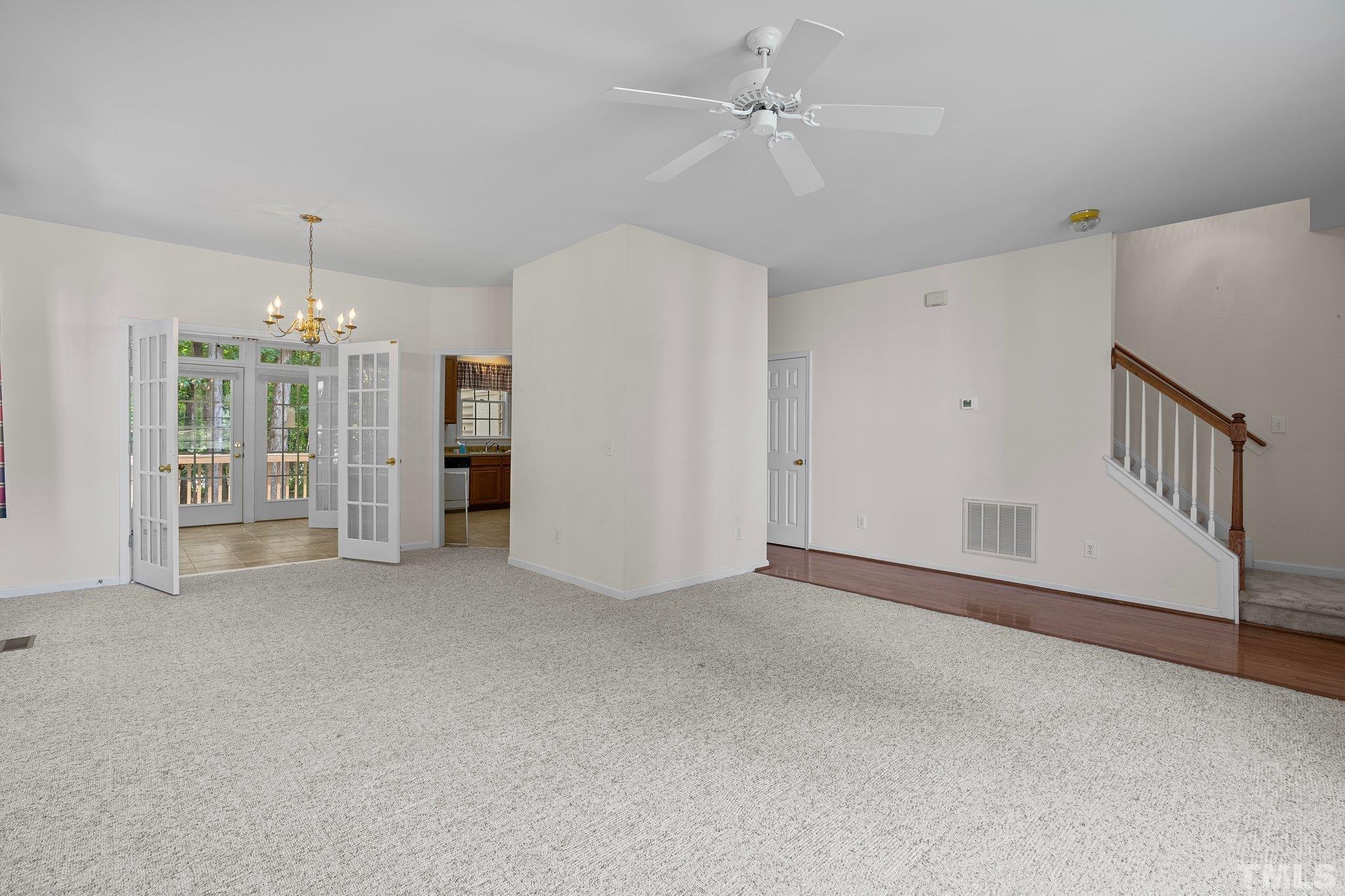 37 Lure Court Durham, NC 27713 - Photo 8 of 35 an empty room with chandelier fan and windows