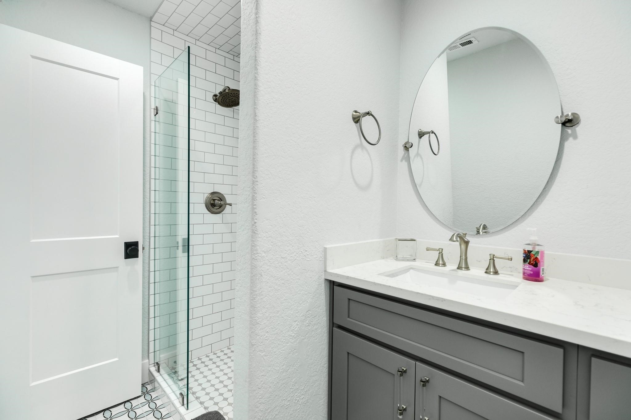 307 Angel Wing Street Surfside Beach, TX 77541 - Photo 13 of 23 a bathroom with a sink vanity and shower