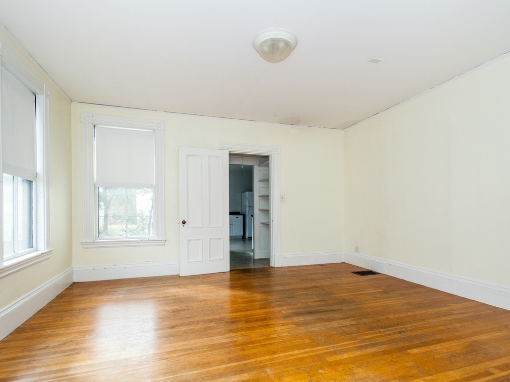 46 Gorham Avenue Brookline, MA 02445 - Photo 13 of 23 an empty room with wooden floor and windows