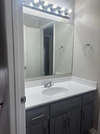 a bathroom with a sink vanity and a mirror