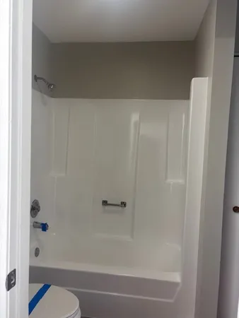 a bathroom with a shower and a toilet