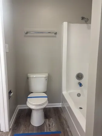 a bathroom with a toilet and a shower