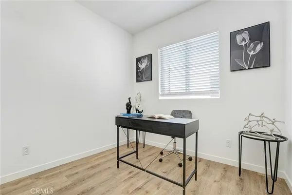 a view of a workspace with furniture and window
