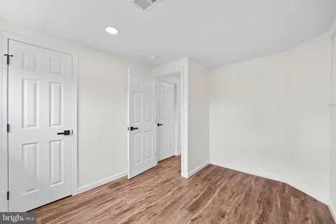 a view of wooden floor and entryway in a room