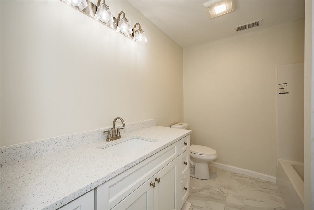 74 West Crystal Brook Drive Springfield, MA 01118 - Photo 11 of 31 a bathroom with a sink a toilet and a mirror