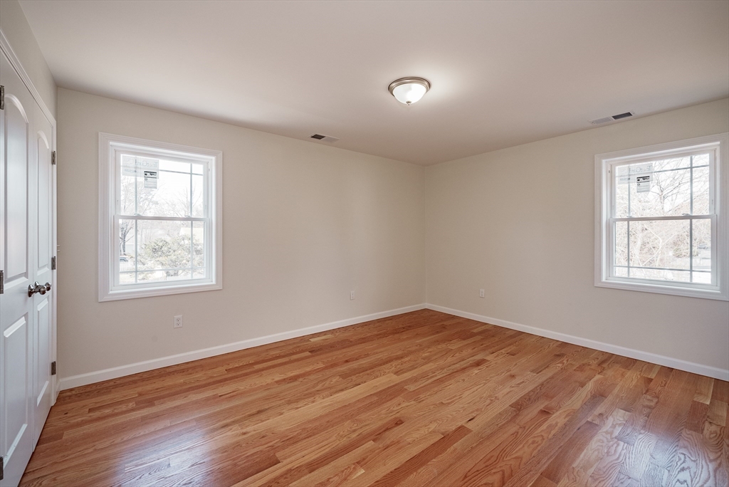 74 West Crystal Brook Drive Springfield, MA 01118 - Photo 12 of 31 an empty room with wooden floor and windows
