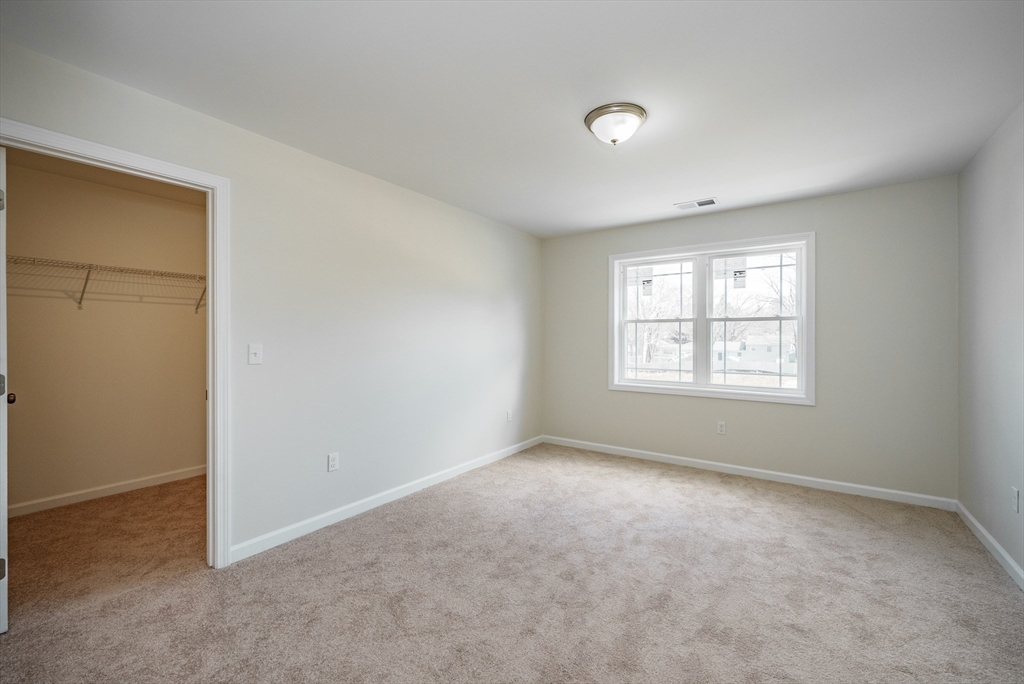 74 West Crystal Brook Drive Springfield, MA 01118 - Photo 16 of 31 an empty room with windows and closet