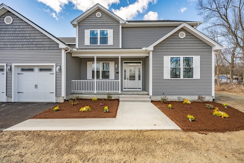 74 West Crystal Brook Drive Springfield, MA 01118 - Photo 2 of 31 a front view of a house with a yard