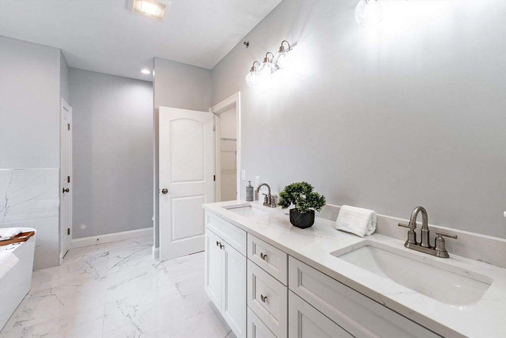 74 West Crystal Brook Drive Springfield, MA 01118 - Photo 21 of 31 a bathroom with a double vanity sink and mirror