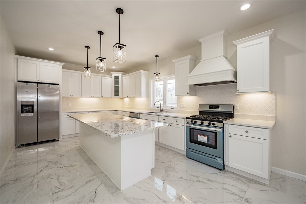 74 West Crystal Brook Drive Springfield, MA 01118 - Photo 7 of 31 a kitchen with stainless steel appliances granite countertop a sink a stove a refrigerator and a oven