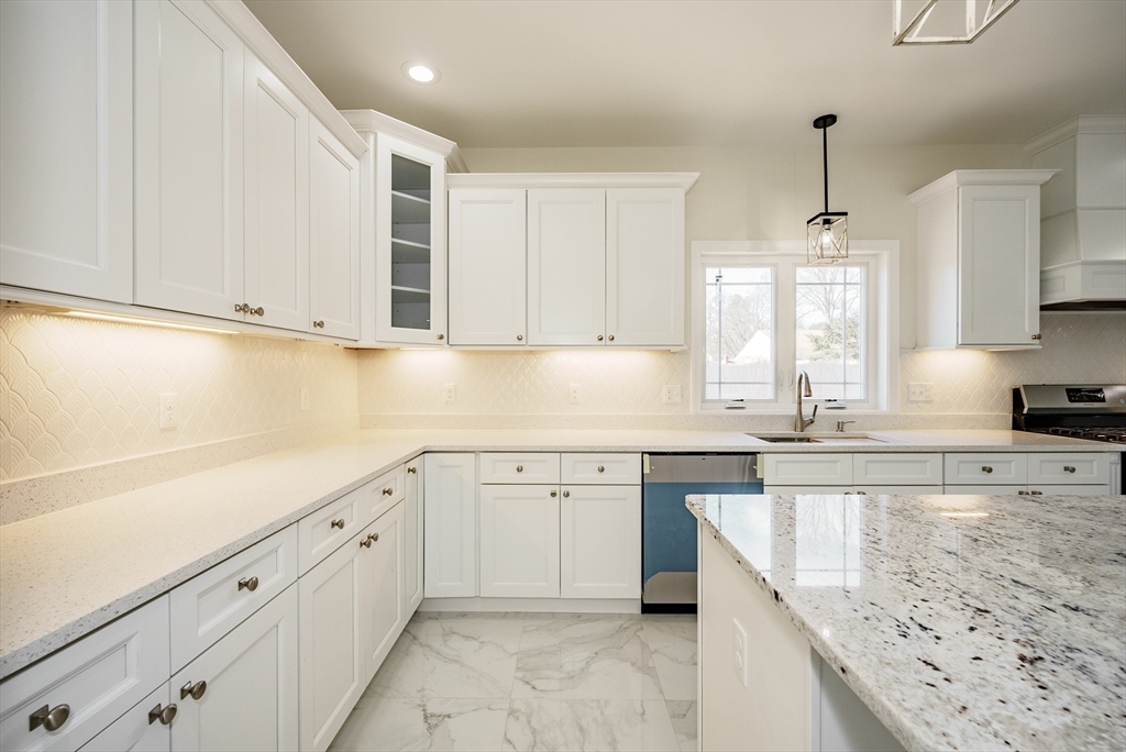 74 West Crystal Brook Drive Springfield, MA 01118 - Photo 8 of 31 a kitchen with granite countertop white cabinets white appliances with a sink and dishwasher
