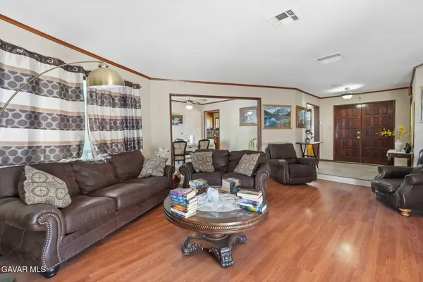 a view of a house with a yard and sitting area