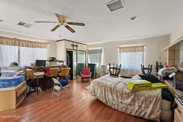 a bedroom with a bed and a dresser in it