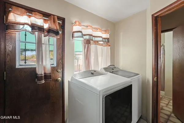 a utility room with lots of clutter and cabinets
