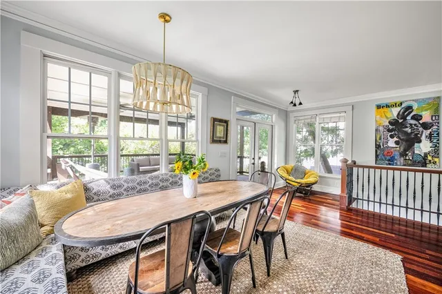 a dining room with furniture a rug and a chandelier