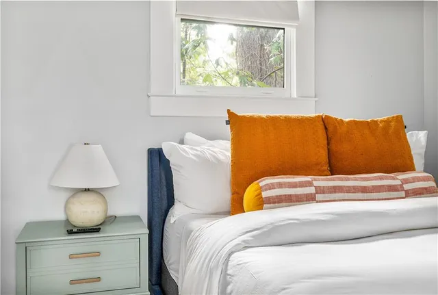 a bedroom with a bed and a window