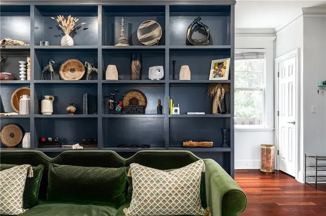 a living room with baby cabinets and book shelf