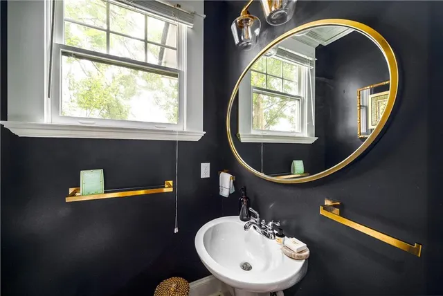 a bathroom with a double vanity sink mirror and toilet