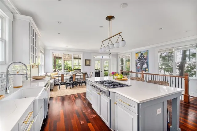 a kitchen that has a stove a table and chairs in it