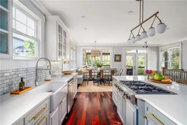 a kitchen with lots of counter top space a sink appliances and cabinets