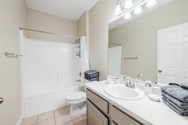 a bathroom with a sink toilet tub and shower