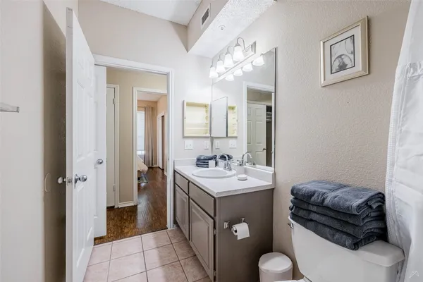 a bathroom with a toilet a sink and a shower