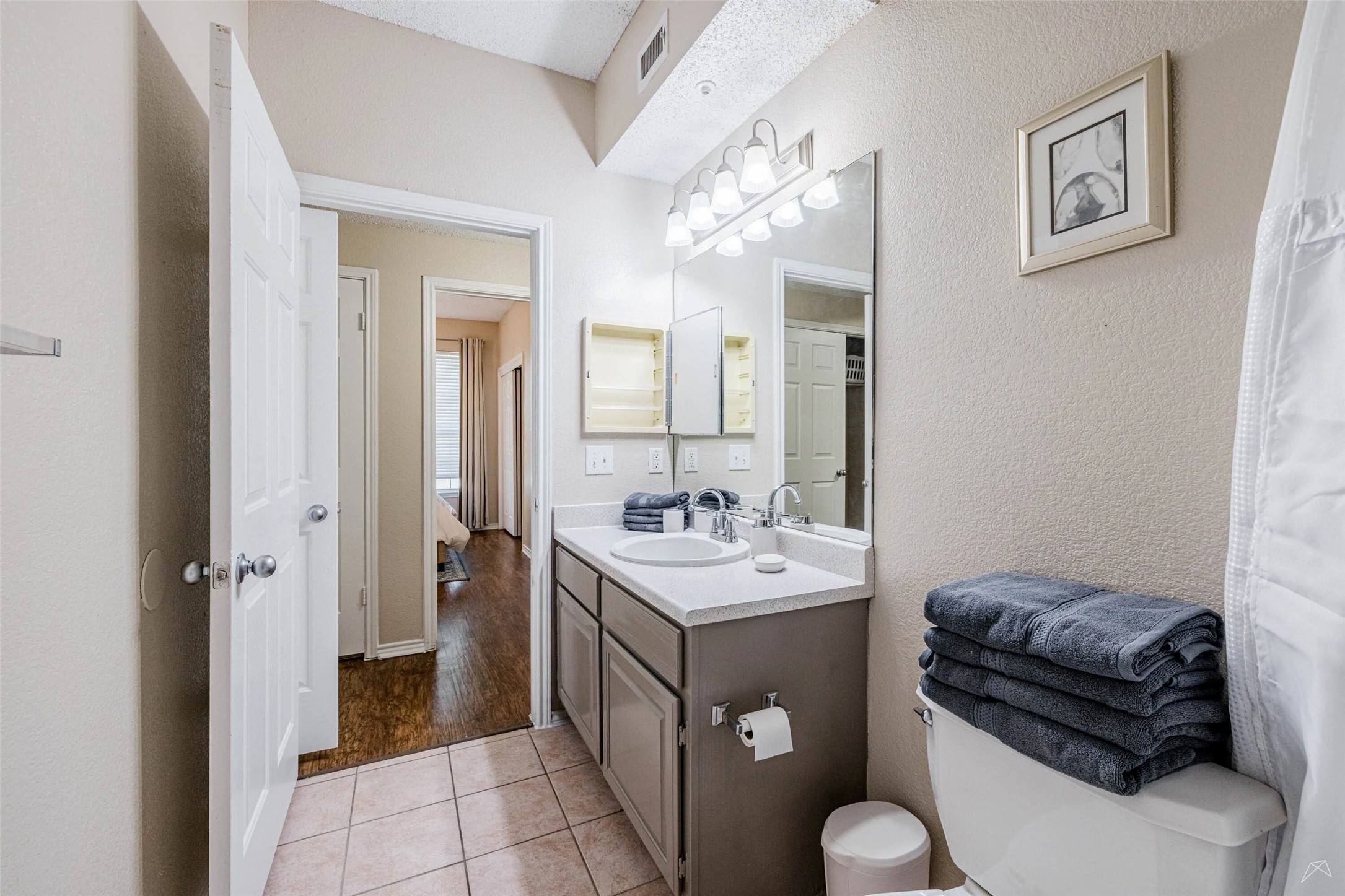 11908 Anderson Mill Road, Unit 312 Cedar Park, TX 78613 - Photo 13 of 25 a bathroom with a sink a mirror and a toilet