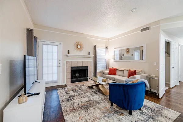 a living room with furniture and a fireplace