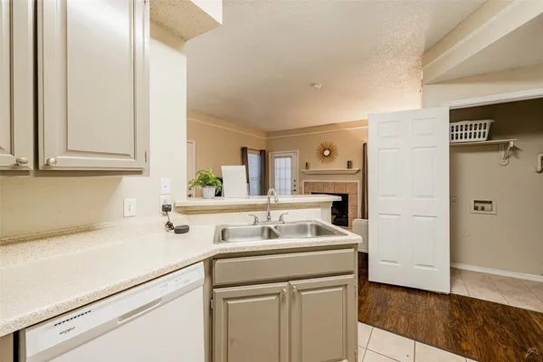 a utility room with cabinets washer and dryer