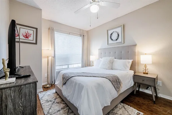 a bedroom with bed and a chandelier